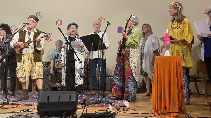 A group of folk performers onstage.