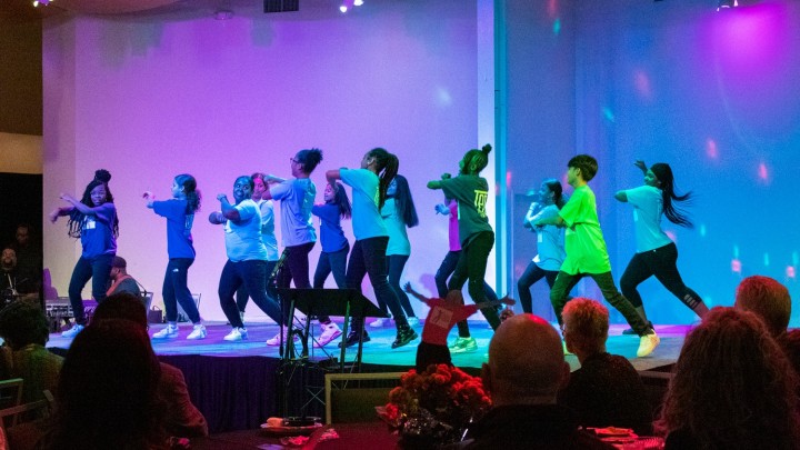 Children performing on a brightly colored stage