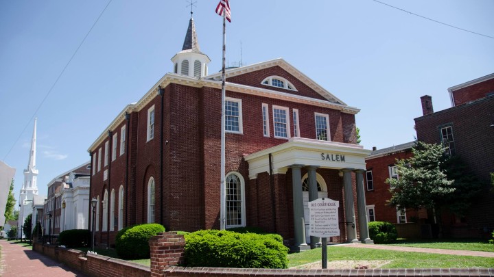 A brick building is red with the word Salem written on it.
