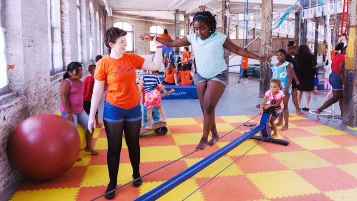 Children playing in a brightly colored circus gym.