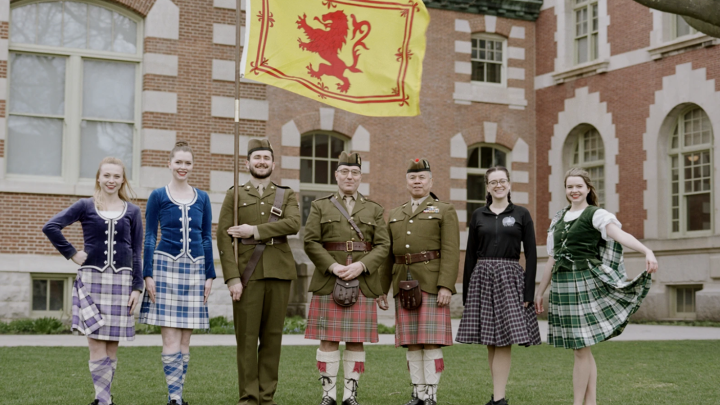 Members of The Learned Kindred of Currie posing in authentic Scottish attire