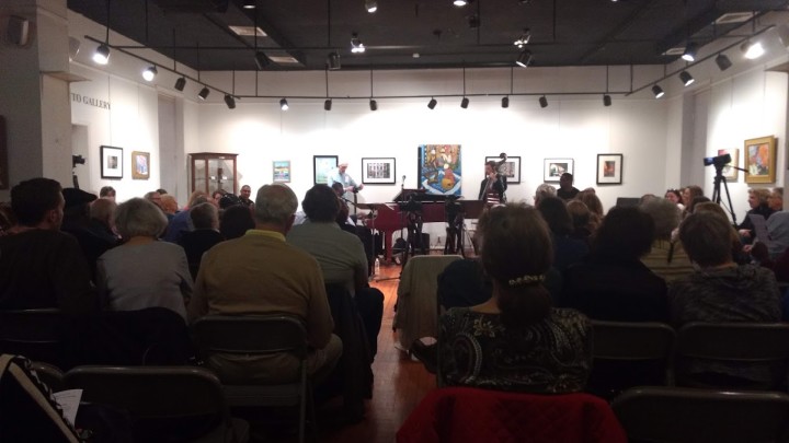 A group of people attending a concert in an art gallery